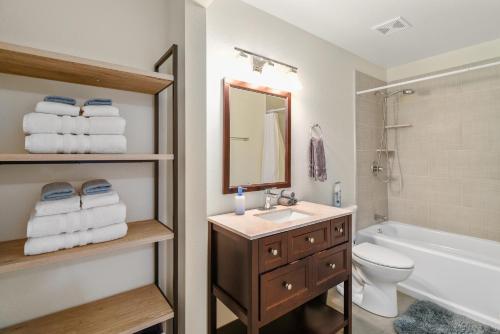 a bathroom with a sink and a toilet and a mirror at Captivating Downtown Greenlaw Getaway to the Mountains with AC! in Flagstaff