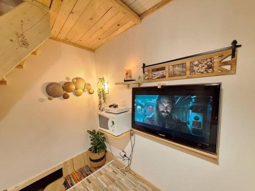a living room with a large flat screen tv on the wall at Cabane chez sam et gael in Charix