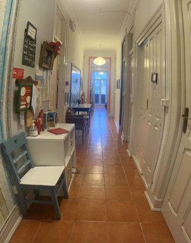 a hallway with a desk and a chair in a room at Peniche Hostel in Peniche