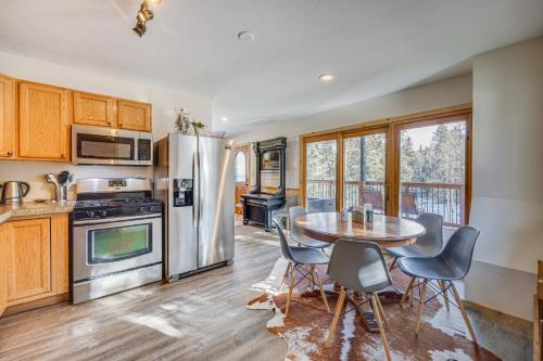 a kitchen with a table and chairs and a refrigerator at Pet-Friendly Florissant Cabin with Fire Pit! in Florissant
