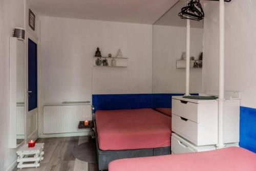 a room with a bed and a nightstand with two beds at Nice 2 double Bed in sunny House in Amsterdam west in Amsterdam