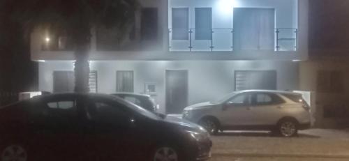 two cars parked in front of a building at night at Apartments A&A - Santa Maria in Santa Maria