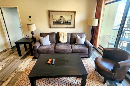 a living room with a couch and a coffee table at Walkable to Mainstreet and Lifts in Park City