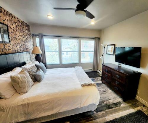 a bedroom with a bed and a flat screen tv at Walkable to Mainstreet and Lifts in Park City