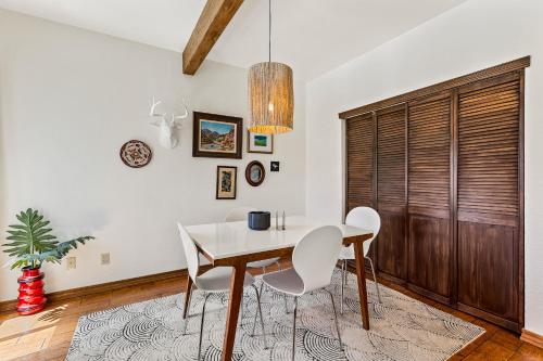 a dining room with a white table and chairs at Delightful 1 bdrm Country Club Retreat with Mt Elden Views! in Flagstaff