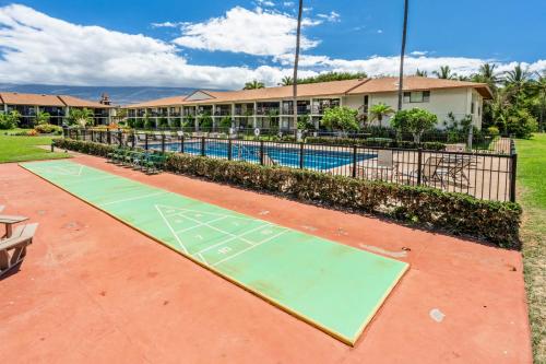 a basketball court in front of a building with a pool at WBH D225 Aloha Ola - Ocean and Pool View in Kihei