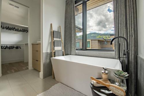 a white bath tub in a bathroom with a window at FREE Daily Maid Service! in Park City