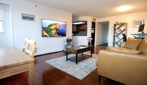 a living room with a couch and a table at Cambridge 2 BR king gym Near Uni RUH City H in Saskatoon