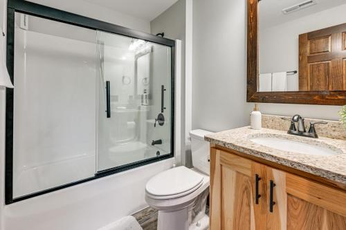 a bathroom with a shower and a toilet and a sink at New Lisbon Vacation Rental Near Castle Rock Lake in New Lisbon