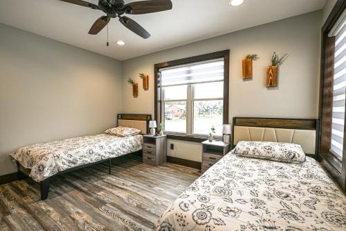 a bedroom with two beds and a window at New Lisbon Vacation Rental Near Castle Rock Lake in New Lisbon