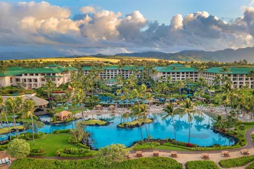 an aerial view of a resort with blue water at Grand Hyatt Kauai Resort & Spa in Koloa