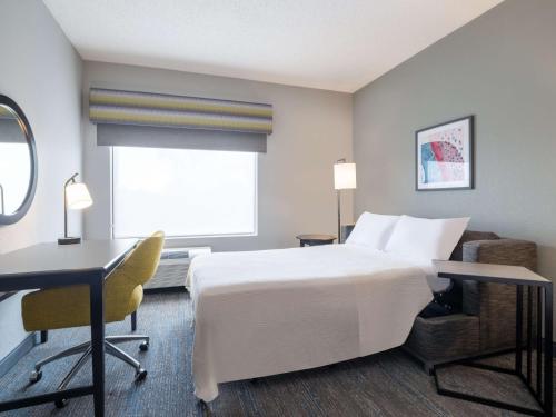 a hotel room with a bed and a desk at Hampton Inn West Palm Beach-Florida Turnpike in West Palm Beach