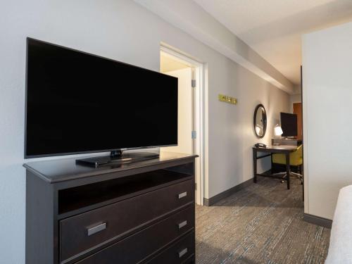 a flat screen tv on a dresser in a hotel room at Hampton Inn West Palm Beach-Florida Turnpike in West Palm Beach