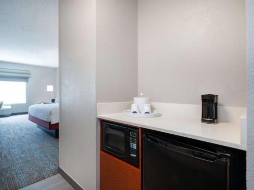 a hotel room with a kitchen and a bed at Hampton Inn West Palm Beach-Florida Turnpike in West Palm Beach