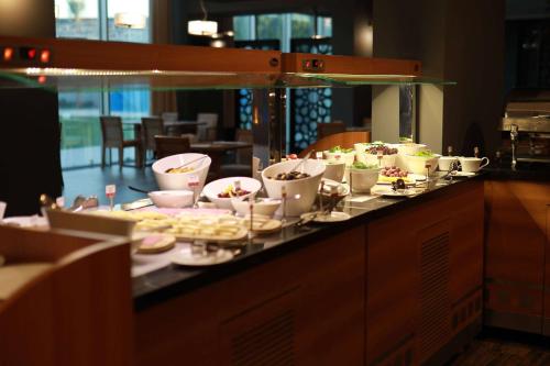 a buffet line with plates and bowls of food at Ramada By Wyndham Soma in Soma