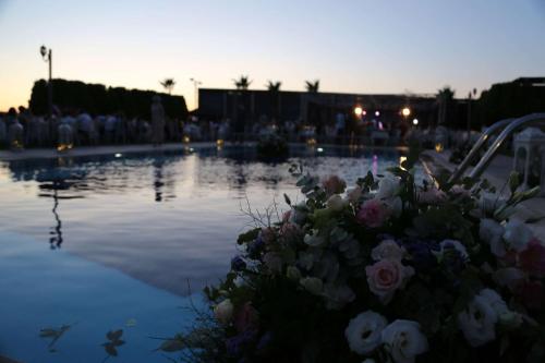 a pool of water with a bunch of flowers at Ramada By Wyndham Soma in Soma