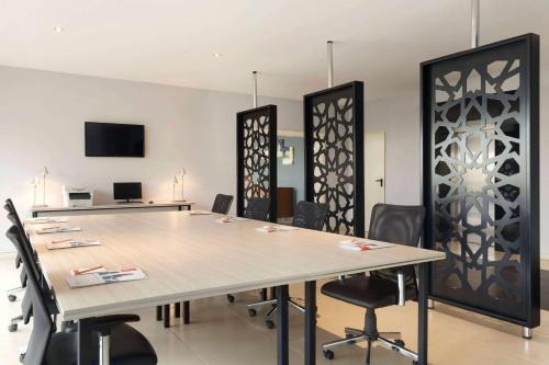 a conference room with a large table and chairs at Ramada By Wyndham Soma in Soma