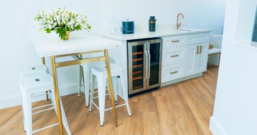 a kitchen with a white counter and a table with flowers at Ivory Sands Beach Suites in Clearwater Beach