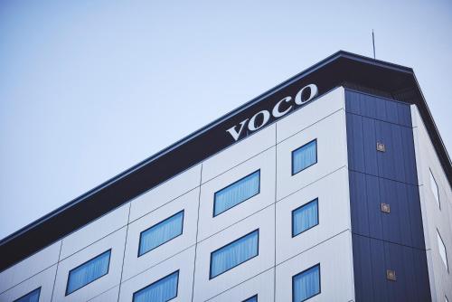 a building with a voco sign on top of it at voco Osaka Central by IHG in Osaka