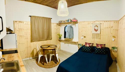 Habitación con cama azul y mesa. en Studio Plaza Molino del Gofio Only Adults, en Granadilla de Abona