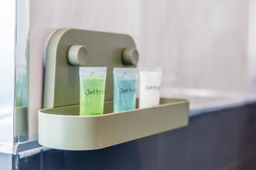 a shelf with three tubes of toothpaste on a wall at New Large 2 Bed entire apartment Near Newcastle upon Tyne with Free Parking in Kenton