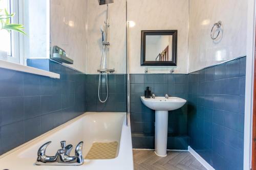 a bathroom with a sink and a bath tub and a sink at New Large 2 Bed entire apartment Near Newcastle upon Tyne with Free Parking in Kenton