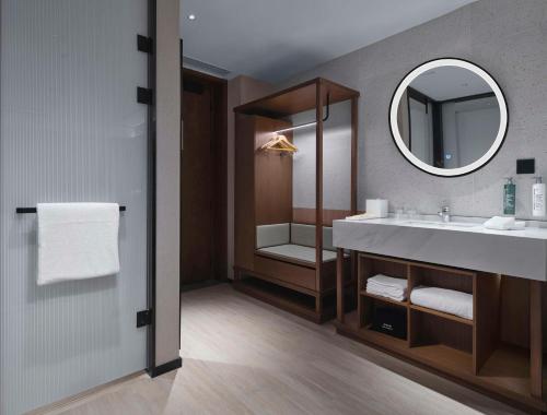 a bathroom with a sink and a mirror at Hilton Garden Inn Nantong Rudong in Nantong