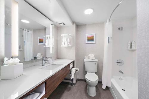 a white bathroom with a toilet and a shower at Hampton Inn Los Angeles Airport in Los Angeles
