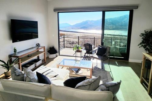 a living room with a couch and a large window at The views! Enjoy this Hideout home. in Keetley