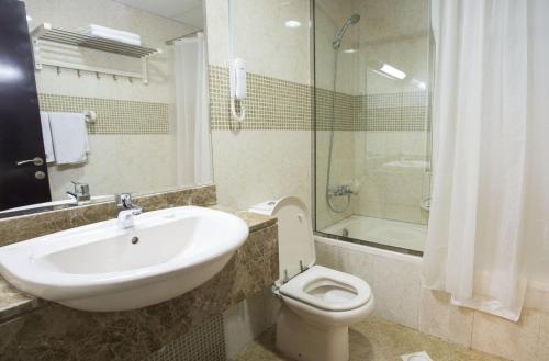 a bathroom with a sink and a toilet and a shower at Dreamy Partition Room in Barsha1 in Dubai