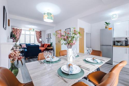 a dining room and living room with a table and chairs at Lincroft House Coventry in Coventry