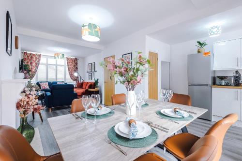 a dining room and living room with a table and chairs at 3Bed Luxury Retreat - Your Perfect Coventry Holiday Home Away in Coventry