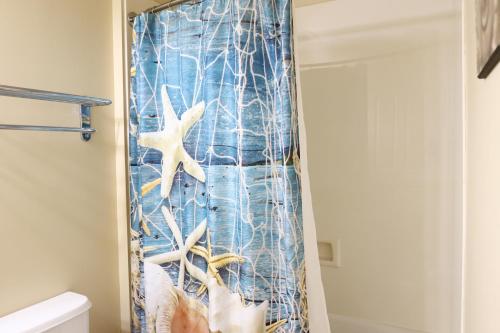 a shower curtain in a bathroom with a starfish at AQUA 1504 Beachfront condo with Free Beach Chairs in Panama City Beach