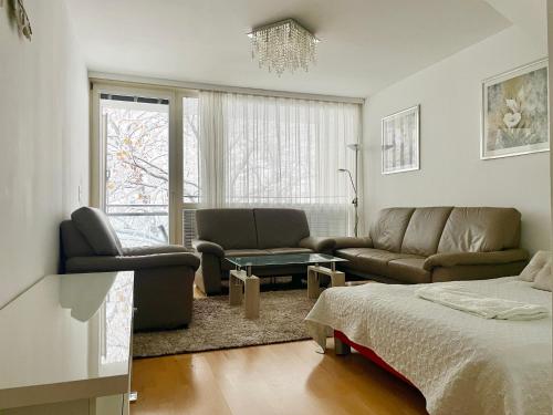 a living room with a couch and a bed at 90 m2 Maisonette with Free Parking in Vienna