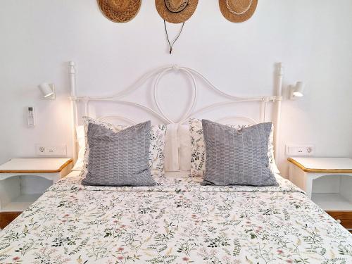 a bedroom with a white bed with pillows at Casa Limoncello in Puerto del Carmen