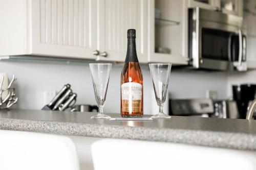 a bottle of wine sitting on a counter with two wine glasses at The Shores in Williamsburg