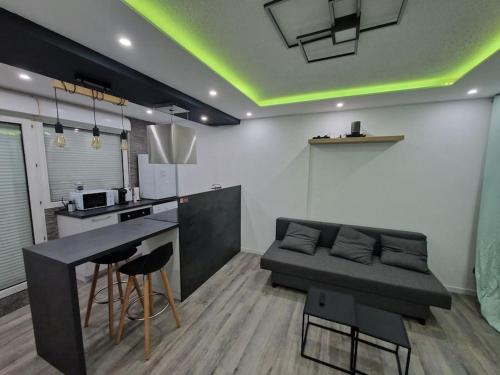 a kitchen with a couch and a table in a room at Logement Atypique in Gex