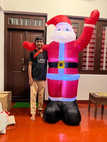 a man standing next to a person in a santa claus costume at Marari Beach Villas in Mararikulam