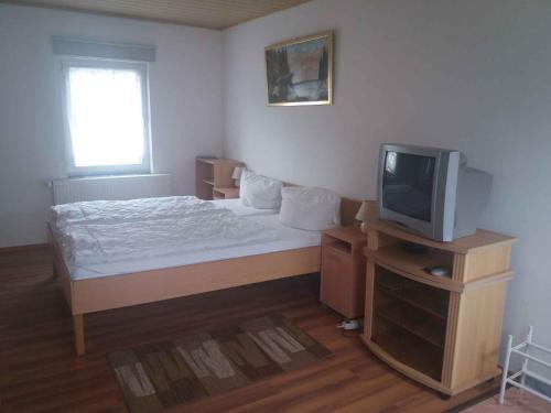 a small bedroom with a bed and a tv at Studio in Usedom - Insel Usedom 2319 in Welzin