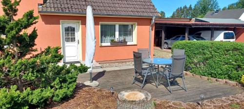 a patio with a table and chairs in front of a house at Apartment in Sehlen/Insel Rügen 3026 in Sehlen
