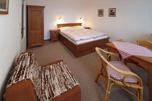 a bedroom with a bed and a table and chairs at Holiday home Pekov - Adrspach-Felsen 1432 in Pěkov