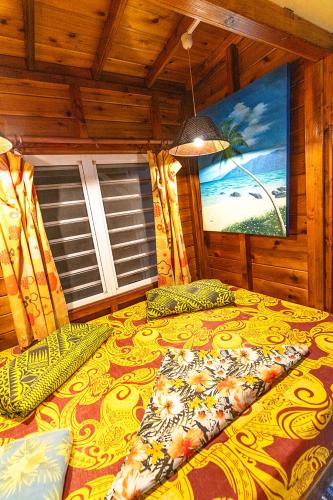a bedroom with a large bed in a room at Heimanarii's Lodge - Fare Miti in Haapiti