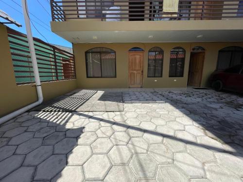 a house with a patio in front of it at Casa Bella Vista in Quepos