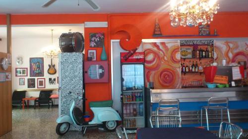 a restaurant with a scooter parked next to a bar at Hotel Villa Elia in Rimini