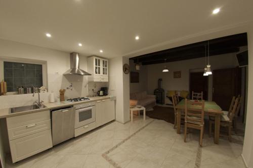 a kitchen and living room with a table and a dining room at Slovácká chalupa in Strážnice