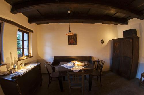 a dining room with a table and a table and chairs at Slovácká chalupa in Strážnice