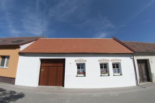 a small white house with a brown roof at Slovácká chalupa in Strážnice