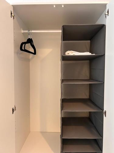 a walk in closet with gray shelves at 93qm-4 Rooms-WiFi-City Centre in Kassel