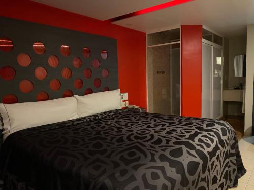 a bedroom with a black and white bed with red walls at Smae in Mexico City