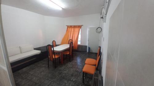a room with a couch and a table and chairs at Esquina La Argentina in San Luis